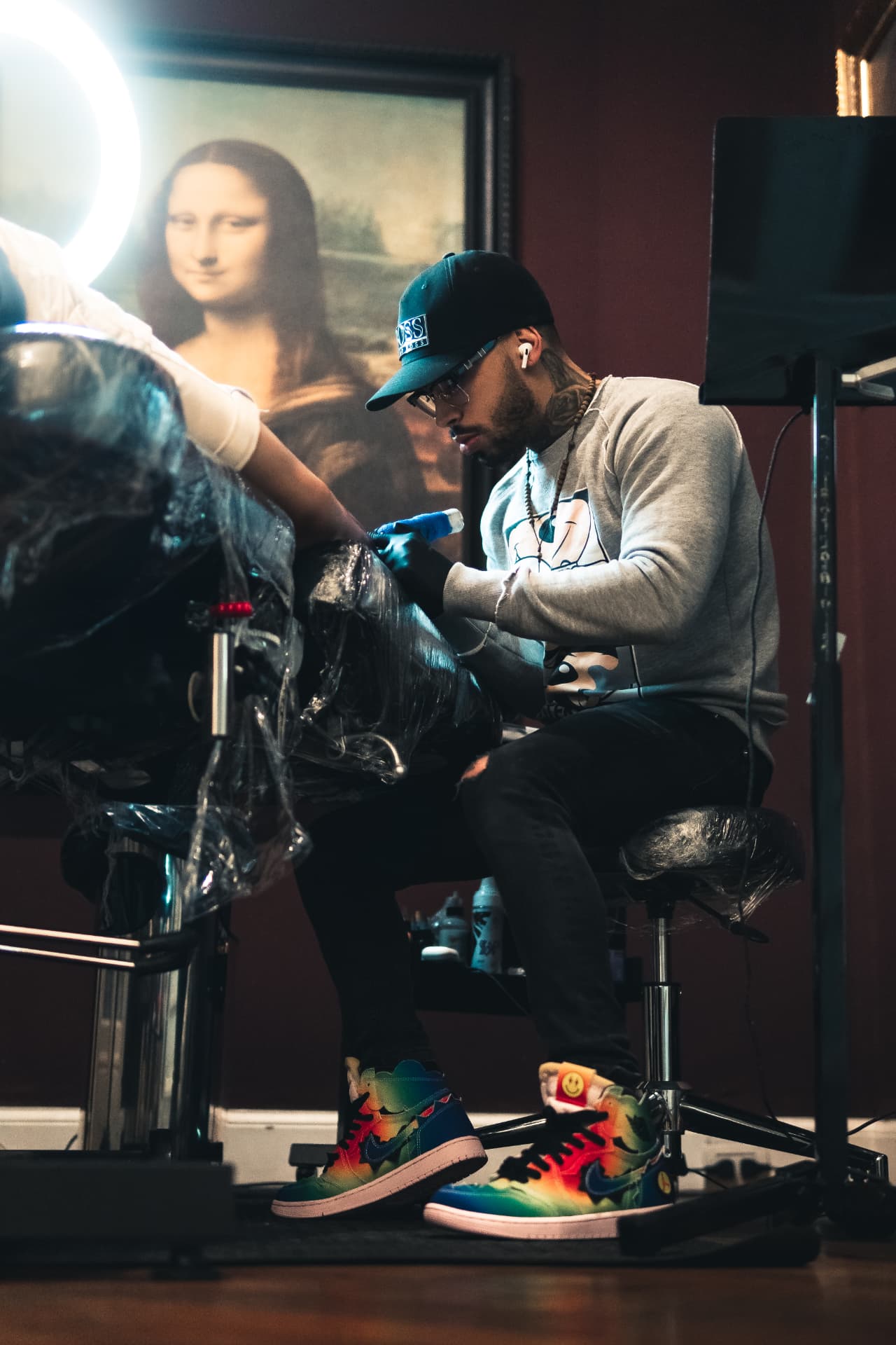 Jean Maurez tattooing a client in his studio